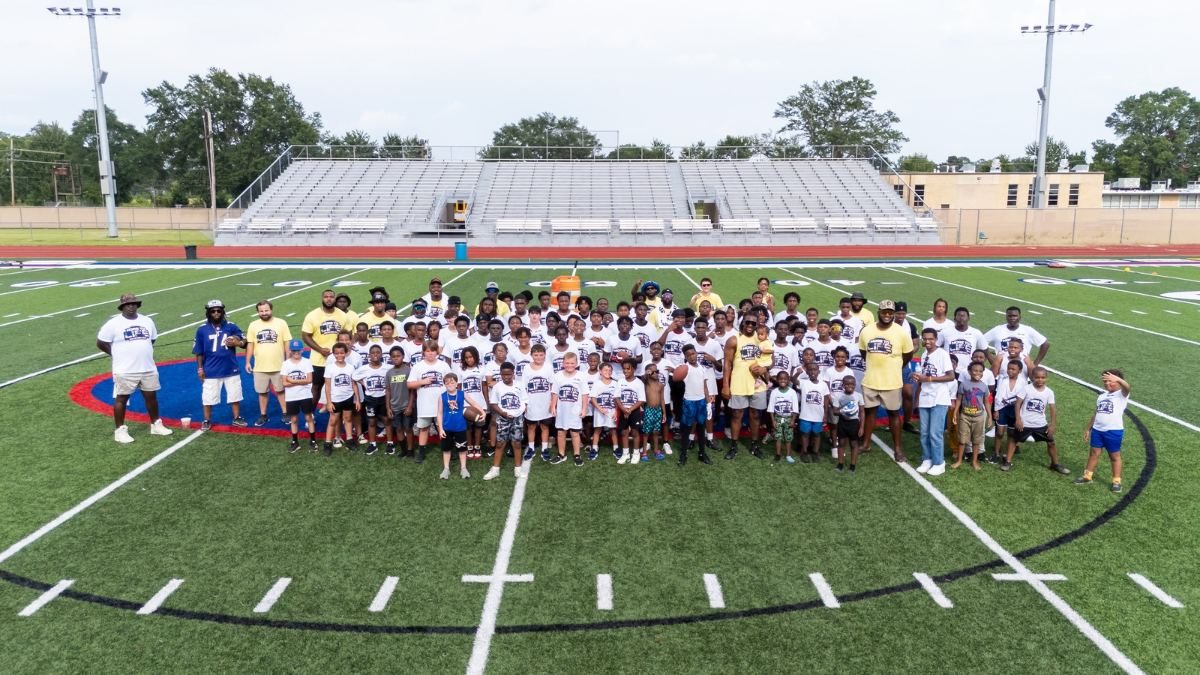 Kids on a football field at a youth clinic